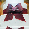 Dark red and white tiered bow tie wedding cake
