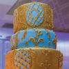 Vintage-inspired gold & blue six tier cake with intricate fondant & buttercream detail