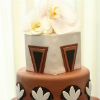 Cream, black & brown fondant three tier cake with fondant patterns & orchid topper