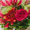 Whimsical bouquet with pink, orange and green floral accents.