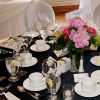 Black and white table décor with pink and red floral accents