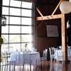 Rustic-themed with white linens, wood chairs and patio lanterns