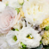 Simple yet elegant bouquet with white peonies, light pink roses and yellow and green accent flowers