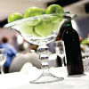 Green apples in a glass bowl centerpiece add a modern touch