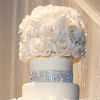 Four tier white cake with crystal trim and blush roses