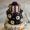 Whimsical four-tiered cake with orange calla lillies