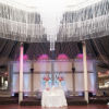 Stunning crystal chandelier and crystal ceiling accents highlight a head table for two
