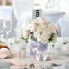 All white place settings, table linens and centerpieces