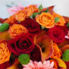 Bold fall bouquet with orange and red roses and coral gerbera daisy accents