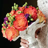 Vibrant orange rose bouquet with green and violet accent flowers
