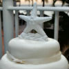 Nautical theme two tier cake with white starfish and seashell topper