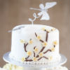 Four tier white and yellow cupcake tower with a full white cake top tier with butterfly topper and yellow cherry blossom fondant