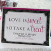 Candy table with hot pink signs and accents.