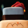 Blue, cream and brown three tier cake with chocolate brown ribbon trim and red calla lily