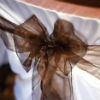 Satin chair cover with sheer brown bow