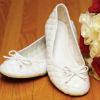 White quilted ballet flats with bow toe detail