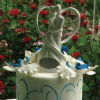 White & blue three tier cake with sheer blue ribbon trim & couple silhouette topper