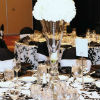 Black & white décor, black satin napkins, tall white flower centerpieces