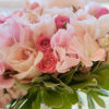 Classic bouquet with hot pink, light pink and white roses, and white peonies.